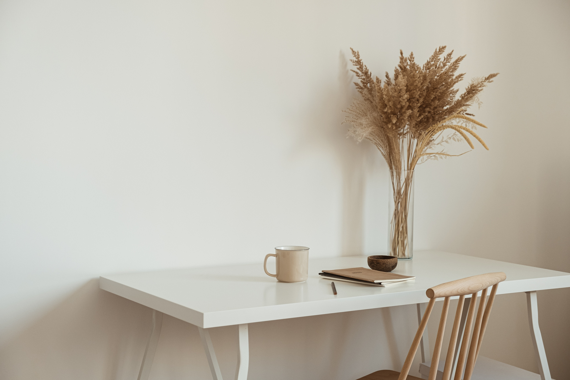 Notebooks, Pen, Cup and Flower Vase on Table with Chair